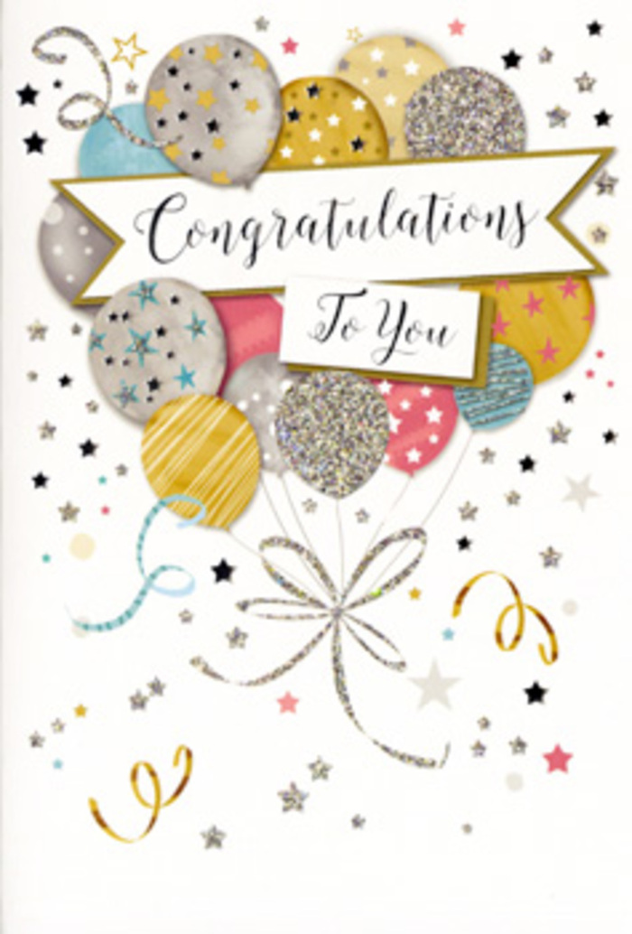 In this photograph, a refined congratulations card stands against a neutral backdrop, its design echoing the cheerful mood of a celebration in Greenford's neighbourhood streets and parks. The illustration features an airy bouquet of helium balloons clustered in the centre, gently ascending as if lifted by shared pride and joy. The balloons are painted in a harmonious palette of gold, silver, champagne, sky blue, blush pink, and soft grey, each one decorated with dainty stars, shimmering glitter textures, or slim bands that catch the light. From the base of the cluster, slender ribbons spill downward in metallic gold and silver, looping gracefully as they converge at the bottom edge, suggesting the careful hand of an artist-or a florist tying the last ribbon on a gift bouquet. A wide, softly curved banner stretches across the middle of the balloons, bearing the phrase Congratulations To You in elegant, looping script that feels both celebratory and heartfelt. The backdrop of the card is a warm ivory tone, sprinkled with scattered metallic stars, tiny dots, and swirling streamers, reminiscent of confetti drifting through the air after a party near Ravenor Park. Gentle shadows around the card hint at natural daylight, giving the metallic accents a subtle glow without overwhelming the design. The overall effect is polished yet joyful, ideal to accompany flowers sent for graduations, exam results, or a new job in Greenford. It feels like the kind of card you might thoughtfully select at Greenford Florist to match a sophisticated bouquet, ensuring your congratulations are expressed with both style and sincerity.